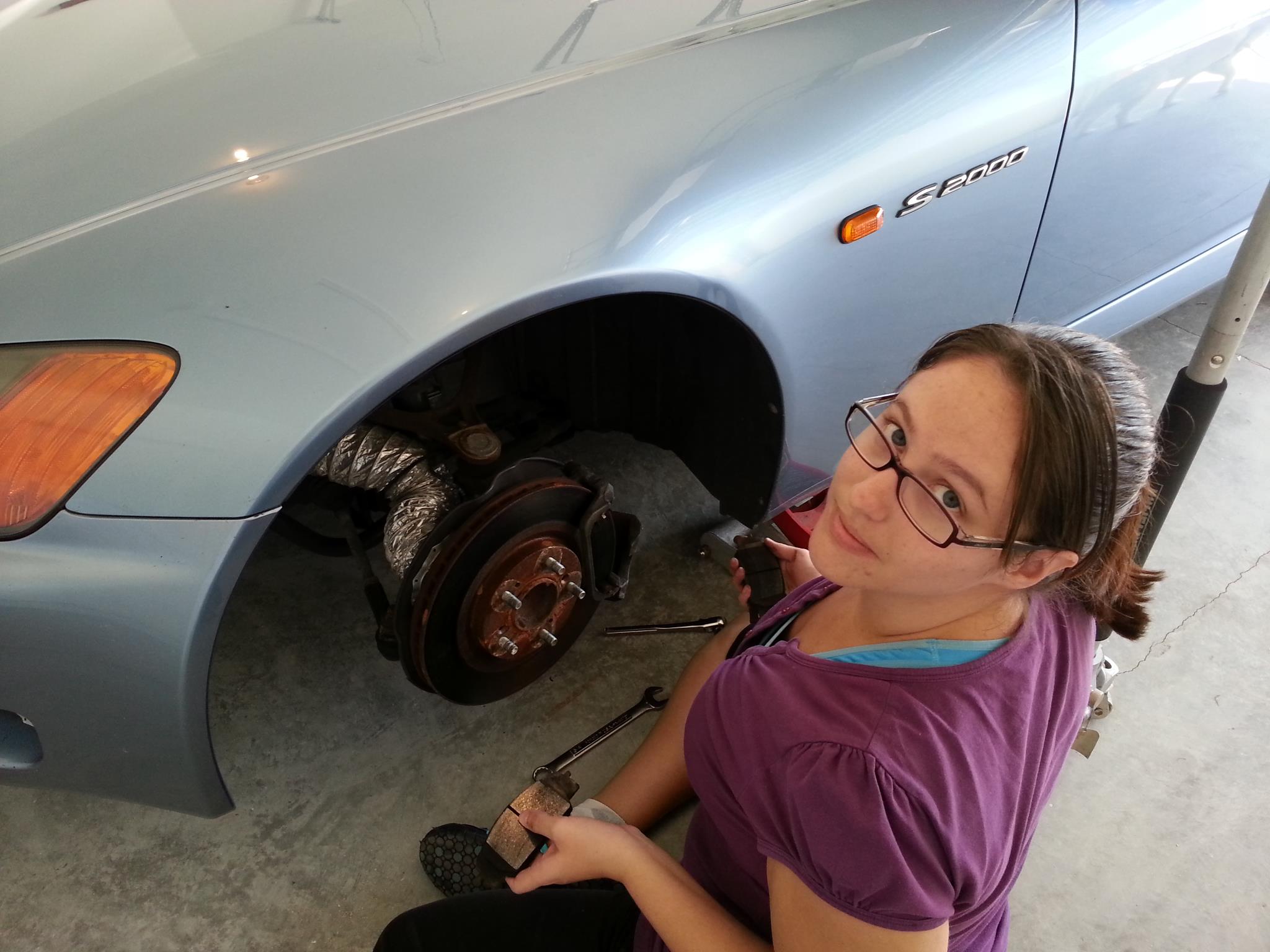 Valerie working on a car